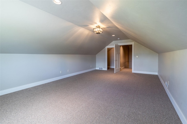 additional living space with lofted ceiling, carpet floors, and baseboards