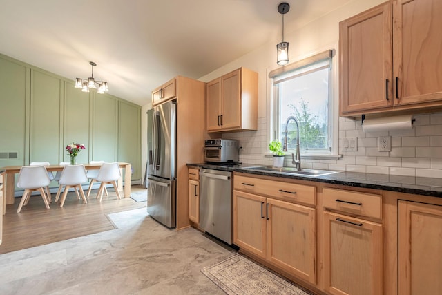 15 Lone Mountain Rd, Clancy, MT 59634 - kitchen with stainless steel appliances, a sink, decorative backsplash, a decorative wall, and light brown cabinetry