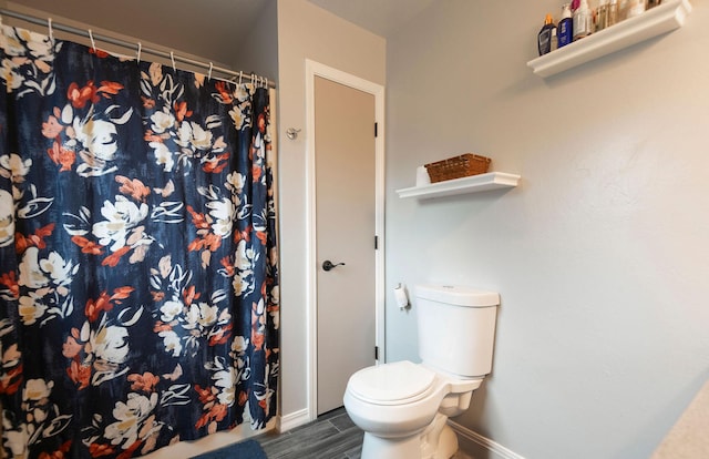 15 Lone Mountain Rd, Clancy, MT 59634 - full bath featuring wood finished floors, baseboards, toilet, and curtained shower
