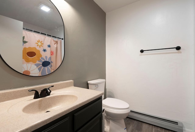 15 Lone Mountain Rd, Clancy, MT 59634 - bathroom with a baseboard heating unit, vanity, toilet, wood finished floors, and a shower with curtain