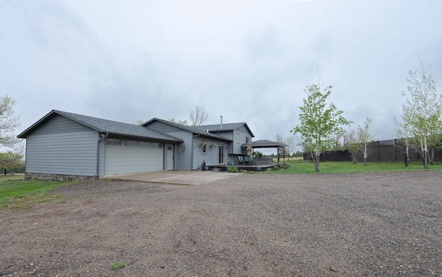 15 Lone Mountain Rd, Clancy, MT 59634 - view of front of house with dirt driveway, an attached garage, and fence