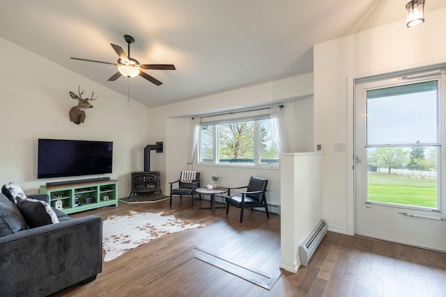 15 Lone Mountain Rd, Clancy, MT 59634 - living area with baseboard heating, a wood stove, ceiling fan, vaulted ceiling, and hardwood / wood-style floors