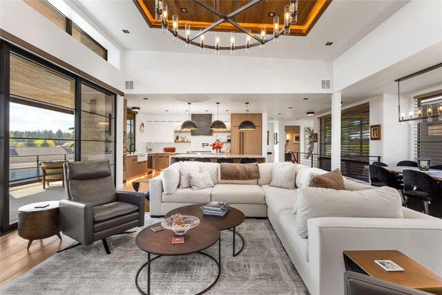 48 Eagle Rock Dr, Bigfork, MT 59911 - living room with a chandelier, light wood-style floors, and a towering ceiling