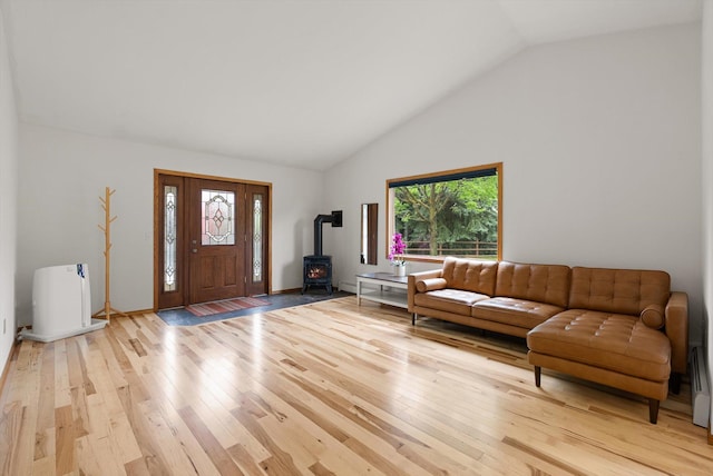 525 Tower St, Missoula, MT 59804 - living room featuring a wood stove, light wood finished floors, and high vaulted ceiling