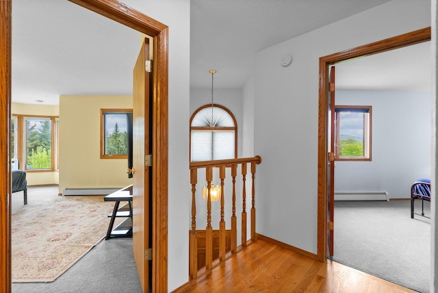 525 Tower St, Missoula, MT 59804 - corridor with a baseboard radiator, baseboard heating, carpet flooring, baseboards, and wood finished floors
