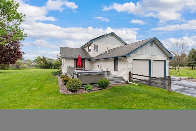 525 Tower St, Missoula, MT 59804 - view of front facade with a hot tub, an attached garage, asphalt driveway, a front lawn, and a deck