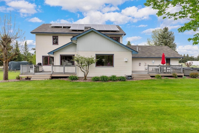 525 Tower St, Missoula, MT 59804 - back of house featuring a yard, a wooden deck, and roof mounted solar panels