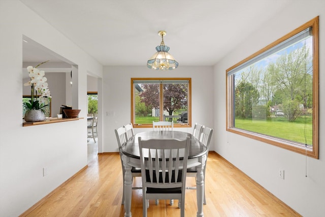 525 Tower St, Missoula, MT 59804 - dining area with a chandelier, healthy amount of natural light, light wood finished floors, and baseboards