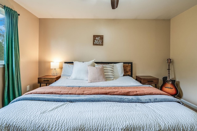 bedroom featuring baseboards and a ceiling fan