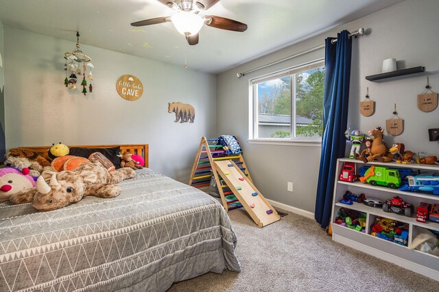 carpeted bedroom featuring baseboards and a ceiling fan
