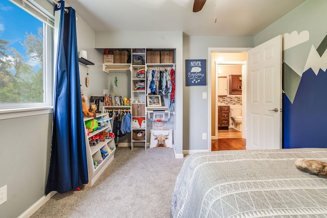 bedroom featuring a closet, carpet flooring, baseboards, and a ceiling fan
