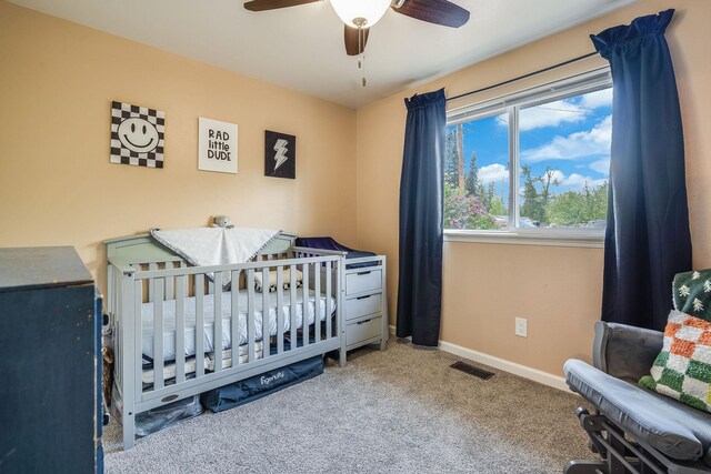 carpeted bedroom featuring baseboards and ceiling fan