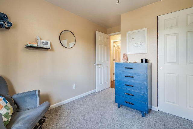 living area with light carpet and baseboards
