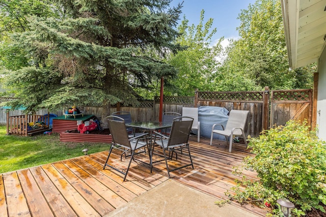deck featuring outdoor dining space and area for grilling