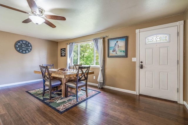 dining area featuring ceiling fan, dark wood-style floors, and baseboards