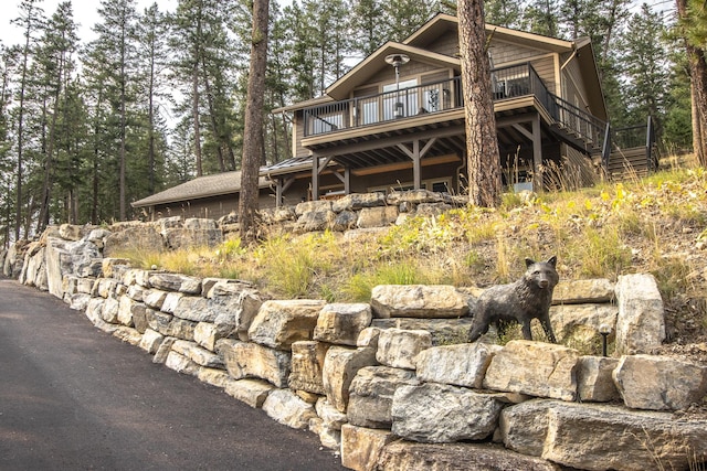 21208 Osprey Loop, Rollins, MT 59931 - view of front facade with a wooden deck and stairway
