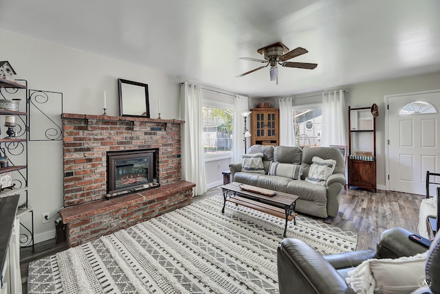 71 Seibold Ln, Cascade, MT 59421 - living area featuring a ceiling fan, wood finished floors, a brick fireplace, and baseboards