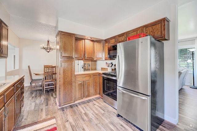 71 Seibold Ln, Cascade, MT 59421 - kitchen featuring stainless steel appliances, a chandelier, light wood finished floors, and light countertops