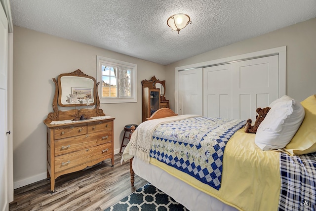 71 Seibold Ln, Cascade, MT 59421 - bedroom with a closet, wood finished floors, a textured ceiling, and baseboards