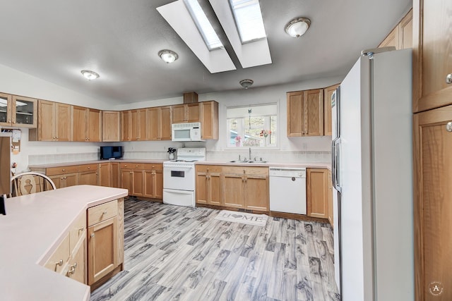 73 Seibold Ln, Cascade, MT 59421 - kitchen with white appliances, a skylight, a sink, light countertops, and light wood-style flooring