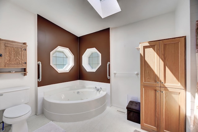 73 Seibold Ln, Cascade, MT 59421 - bathroom featuring a whirlpool tub, toilet, a skylight, and baseboards