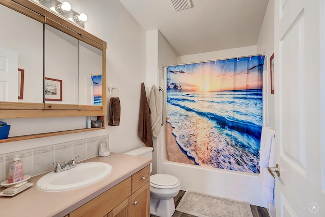 bathroom with tasteful backsplash, toilet, vanity, and shower / bath combination with curtain