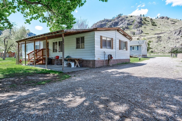 73 Seibold Ln, Cascade, MT 59421 - view of front of house featuring a patio, a mountain view, and driveway