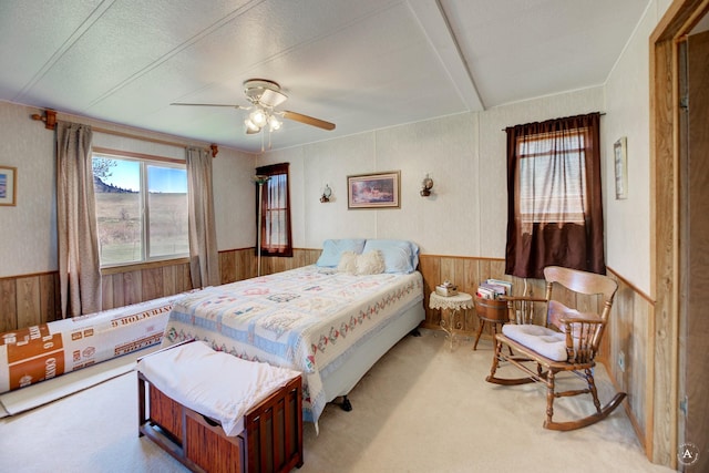 73 Seibold Ln, Cascade, MT 59421 - carpeted bedroom with wood walls, a wainscoted wall, and a ceiling fan