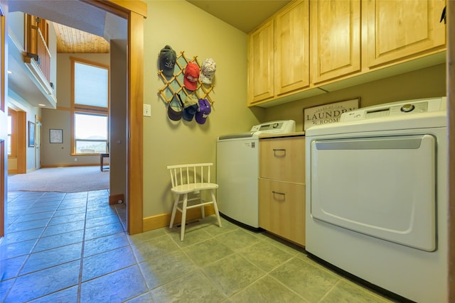 28152 White Swan Ln, Polson, MT 59860 - clothes washing area featuring washing machine and clothes dryer, cabinet space, baseboards, and light tile patterned floors