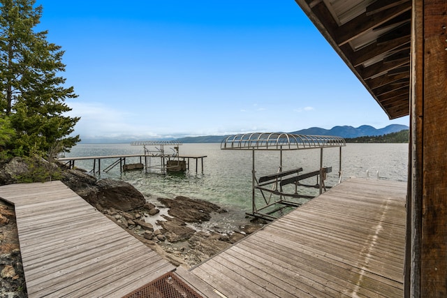 28152 White Swan Ln, Polson, MT 59860 - dock area featuring a water view and boat lift