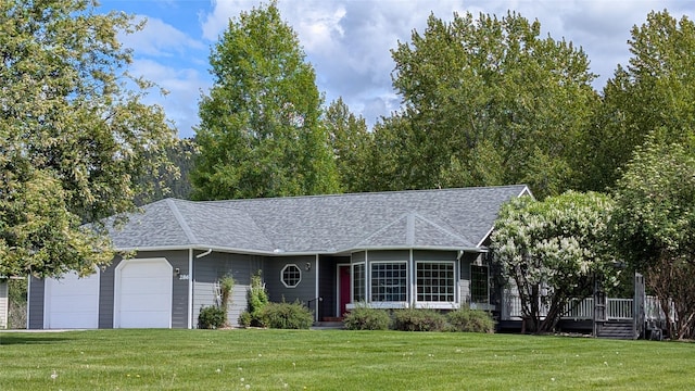 286 Edgewater Dr, Libby, MT 59923 - view of front of home featuring a front lawn, a garage, a shingled roof, and a deck