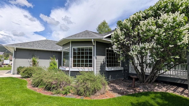 286 Edgewater Dr, Libby, MT 59923 - view of property exterior with a shingled roof, a yard, and a wooden deck