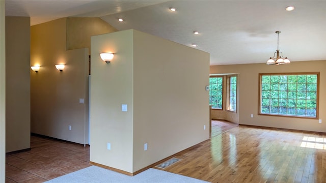 286 Edgewater Dr, Libby, MT 59923 - empty room with recessed lighting, a chandelier, vaulted ceiling, and wood finished floors