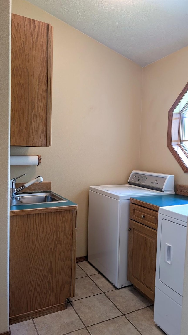 286 Edgewater Dr, Libby, MT 59923 - laundry room with cabinet space, washer and clothes dryer, and light tile patterned flooring