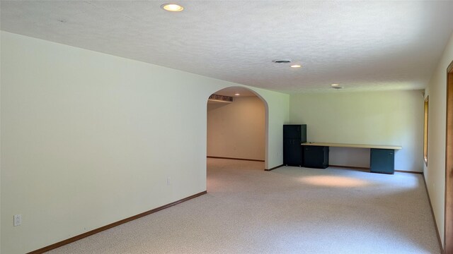 286 Edgewater Dr, Libby, MT 59923 - unfurnished room featuring light carpet, arched walkways, recessed lighting, and a textured ceiling