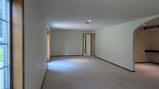 286 Edgewater Dr, Libby, MT 59923 - spare room with arched walkways, light colored carpet, recessed lighting, and a textured ceiling