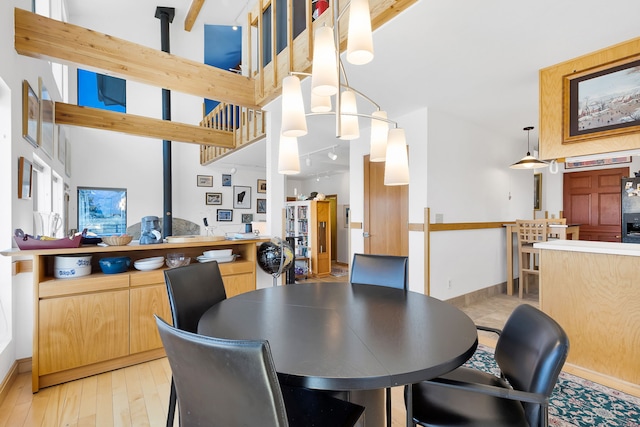 dining room featuring baseboards and light wood-style flooring