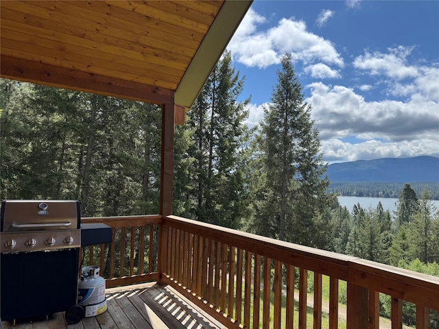 26 Castele Ln, Trout Creek, MT 59874 - wooden terrace featuring grilling area, a view of trees, and a mountain view