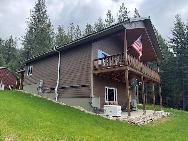 26 Castele Ln, Trout Creek, MT 59874 - rear view of property with a patio area, a yard, a wooden deck, and ac unit