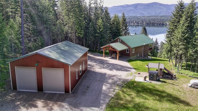 26 Castele Ln, Trout Creek, MT 59874 - detached garage featuring a water and mountain view, a forest view, and driveway