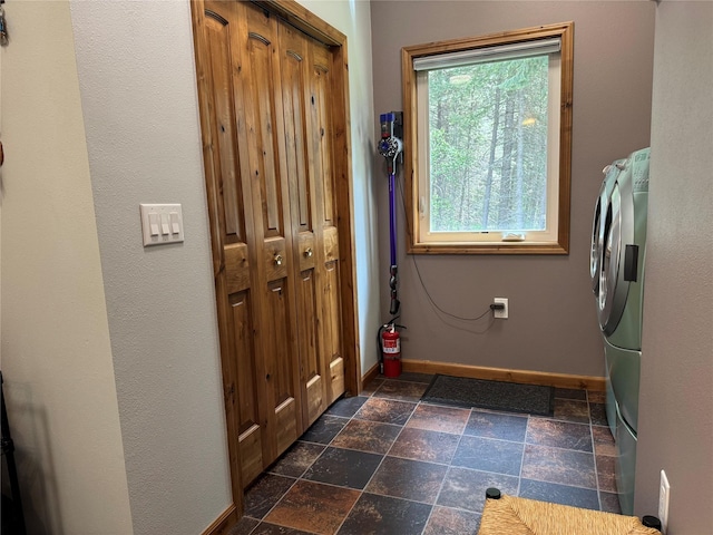 26 Castele Ln, Trout Creek, MT 59874 - washroom with baseboards, stone tile flooring, and washer and dryer