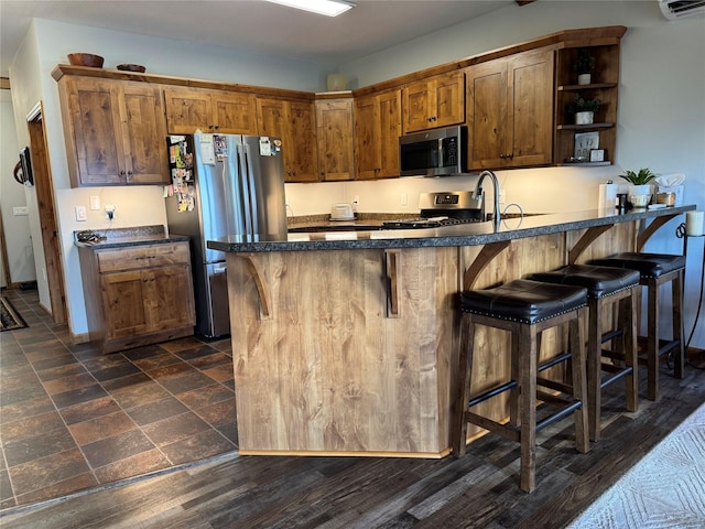 26 Castele Ln, Trout Creek, MT 59874 - kitchen with stainless steel appliances, open shelves, dark countertops, and a kitchen breakfast bar
