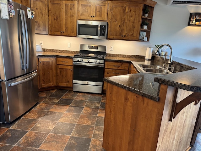 26 Castele Ln, Trout Creek, MT 59874 - kitchen with appliances with stainless steel finishes, a sink, a peninsula, stone tile floors, and dark countertops