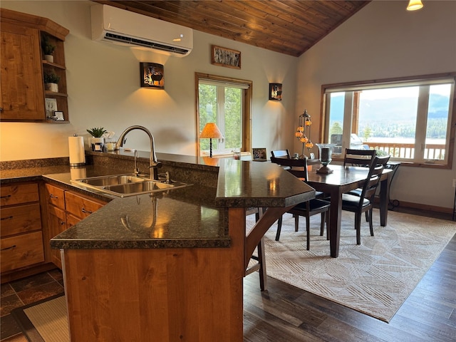 26 Castele Ln, Trout Creek, MT 59874 - kitchen with a sink, a wall mounted AC, a peninsula, brown cabinets, and wood ceiling