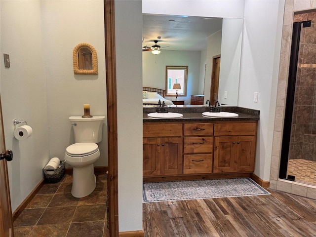 26 Castele Ln, Trout Creek, MT 59874 - full bath with a ceiling fan, a stall shower, double vanity, toilet, and wood finished floors