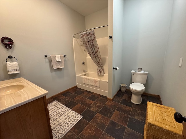 26 Castele Ln, Trout Creek, MT 59874 - bathroom with baseboards, toilet, shower / bath combination with curtain, stone finish floors, and vanity