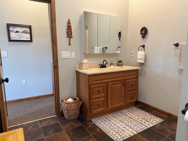 26 Castele Ln, Trout Creek, MT 59874 - bathroom featuring stone tile floors, vanity, and baseboards