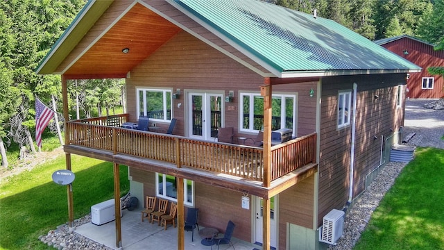 26 Castele Ln, Trout Creek, MT 59874 - back of house featuring a patio area, a deck, a yard, and metal roof
