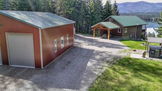 26 Castele Ln, Trout Creek, MT 59874 - detached garage featuring gravel driveway and a mountain view