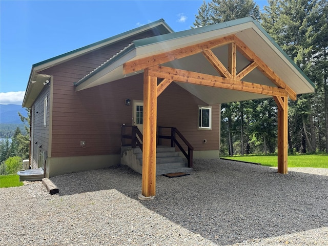 26 Castele Ln, Trout Creek, MT 59874 - view of side of home featuring an attached carport and a mountain view